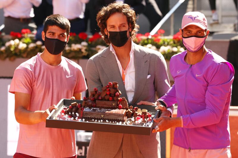 Carlos Alcaraz, left, is presented with a birthday cake by tournament director Feliciano Lopez ahead of his match against Rafael Nadal. Getty