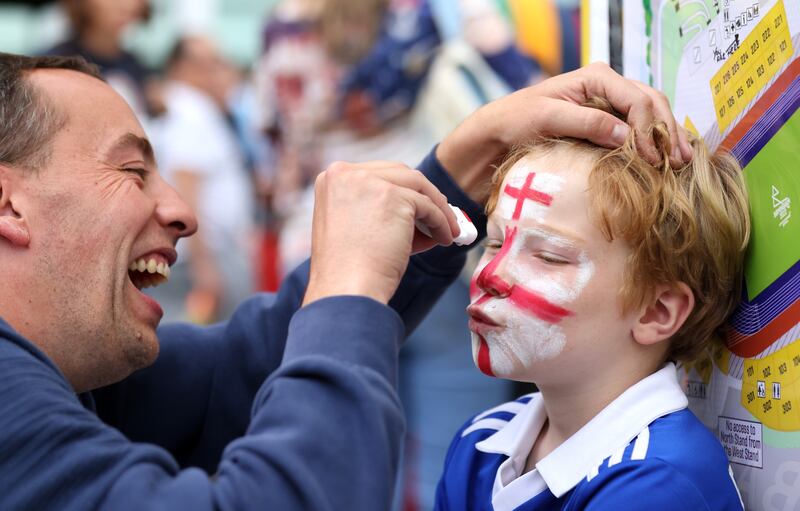 A spectator has his face painted in Team England colours. Getty