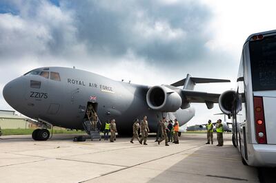 British military personnel disembark a Royal Air Force plane after landing from Afghanistan in Brize Norton, England. AP 