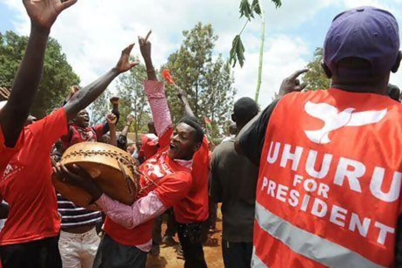 Supporters of Uhuru Kenyatta celebrate upon learning of his victory in Kenya's presidential elections on Saturday. Simon Maina / AFP