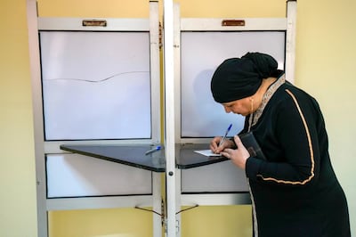 March 27, 2018 -- Cairo-- A woman marks her ballot at a polling station in Shubra. (Dana Smillie for The National)