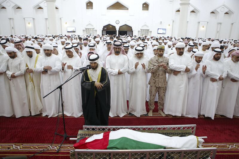 AJMAN , UNITED ARAB EMIRATES , AUG 12 – 2017 :- Sheikh Ammar Bin Humaid Bin Rashid Al Nuaimi, Crown Prince of Ajman ( center ) and family members during the funeral prayers of Sameer Mohammed Murad Abu Bakr , UAE solider who was killed in the helicopter crash in Yemen at the Sheikh Zayed Mosque in Ajman. ( Pawan Singh / The National ) Story by Nick Webster 