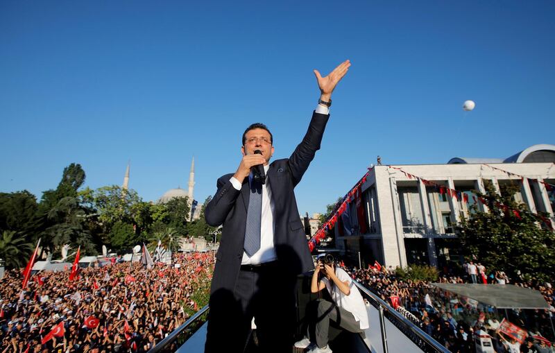 Mr Imamoglu addresses his supporters from the top of a bus outside the City Hall. Reuters