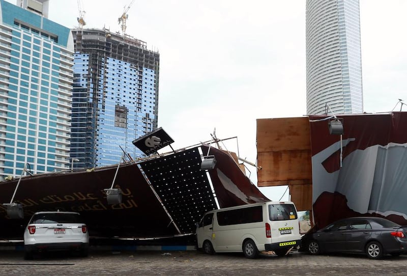 A construction barrier fell onto parked cars in Abu Dhabi. AFP