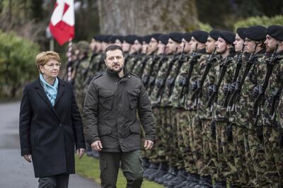 Ukraine's President Volodymyr Zelenskyy, right, will attend the World Economic Forum in Davos starting Tuesday. Here he inspects the guard of honour in Kehrsatz near Bern, Switzerland. AP Photo