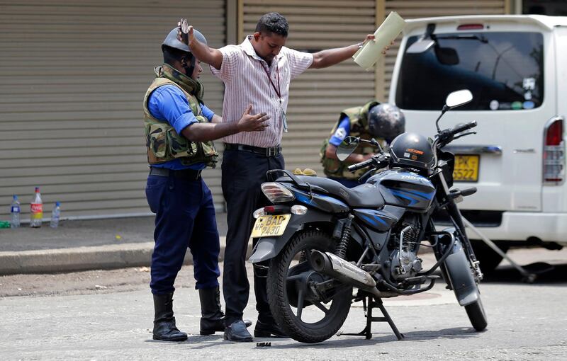 Sri Lankan navy soldiers perform security checks on motorists at a roadside in Colombo, Sri Lanka, Thursday, April 25, 2019. Sri Lanka banned drones and unmanned aircraft and set off more controlled detonations of suspicious items Thursday four days after suicide bombing attacks killed more than 350 people in and around the capital of Colombo. (AP Photo/Eranga Jayawardena)