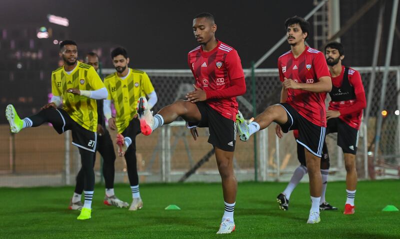 Ali Salmeen, centre, stretches during the training session. Photo: UAE FA