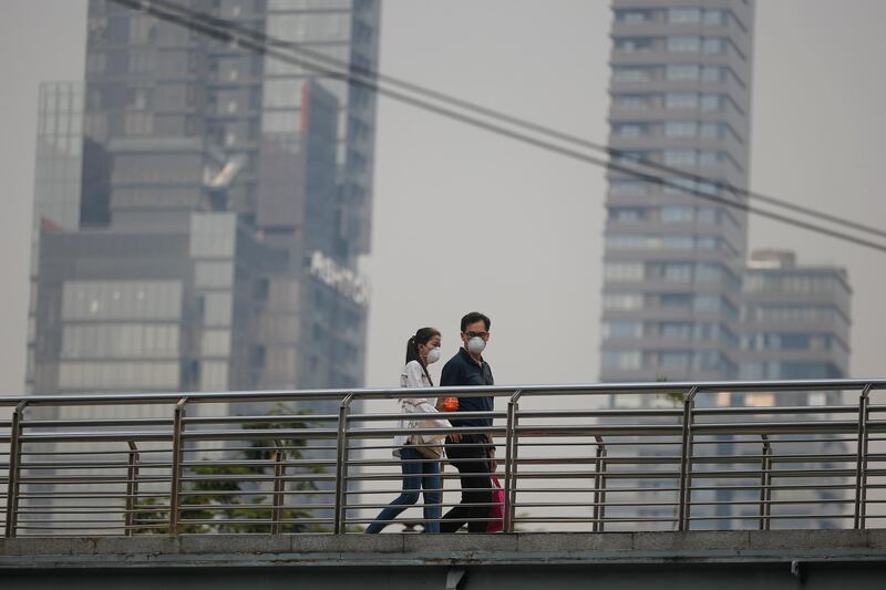 People wear face masks as heavy air pollution continues to affect Bangkok.  EPA