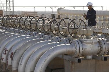 A worker is seen near valves of oil pipes at West Qurna oilfield in Iraq's southern province of Basra. Photo by Reuters