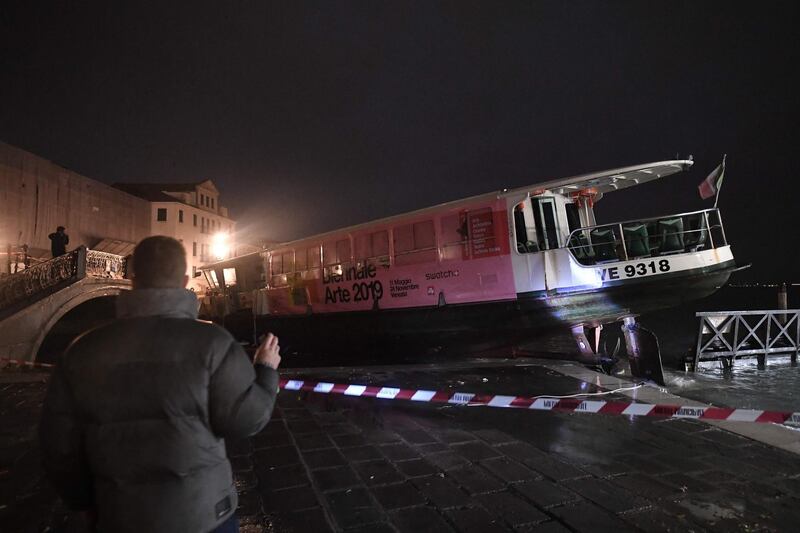 A stranded taxi boat detached from its mooring and pushed over an embankment. AFP