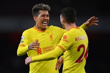 LONDON, ENGLAND - MARCH 16: Roberto Firmino and Andrew Robertson of Liverpool interact following the Premier League match between Arsenal and Liverpool at Emirates Stadium on March 16, 2022 in London, England. (Photo by Justin Setterfield / Getty Images)