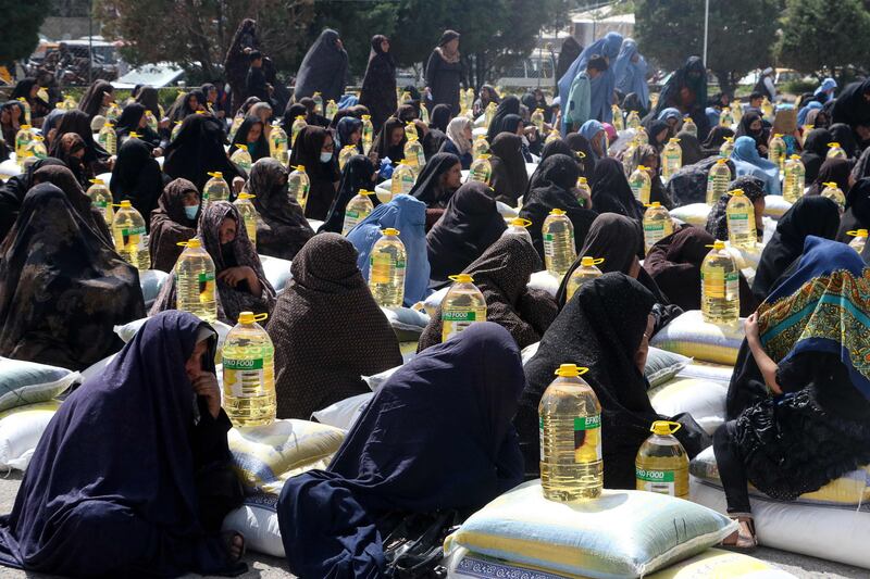 Women in Herat receive food aid distributed by a charity foundation during Ramadan. AFP