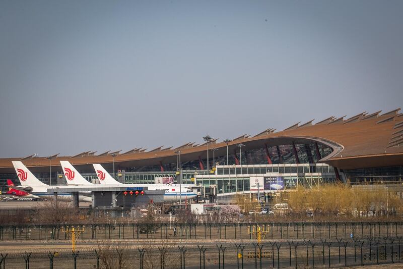 Air China planes are parked at the Capital International Airport, in Beijing, China, on March 17, 2020. EPA