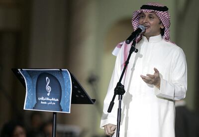 Saudi singer Abdel Majid Abdullah performs during Qatar's Eighth Song Festival in Doha, late 11 January 2007. The festival is hosting several Arab pop and classical singers, including Iraq's top singer Kazem al-Saher, Lebanon's Najwa Karam and Saudi Arabia's Mohammed Abdo. AFP PHOTO/KARIM JAAFAR (Photo by KARIM JAAFAR / AFP)