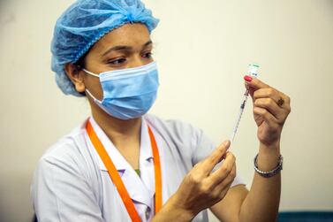 A health worker prepares a dose of the Sinopham vaccine in Dhaka, Bangladesh, on May 25. EPA