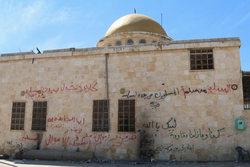 Graffiti is written on the exterior of a mosque in Al Eis after Syrian rebels and the Al Qaeda-affiliated Nusra Front took control of the town, in Aleppo countryside. Ammar Abdullah / Reuters