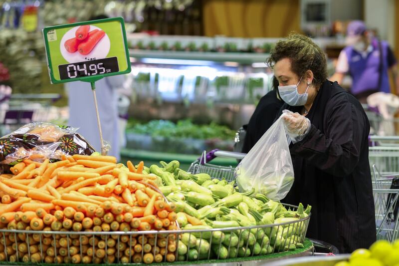 A woman, wearing a face mask buys vegetables at a supermarket, following the outbreak of the coronavirus disease (COVID-19), in Riyadh, Saudi Arabia June 14, 2020. REUTERS/Ahmed Yosri