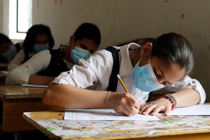 Iraqi students wearing protective face masks take their mid-year exams, amid the spread of the coronavirus disease at a school in Baghdad, Iraq. Reuters