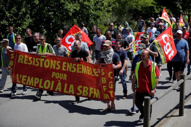 Employees on strike of the Fonderie de Bretagne plant, a subsidiary of Groupe Renault, hold CGT labour union flags during a demonstration against the possible closure of their plant in Caudan, France, May 27, 2020. The banner reads "Let's resist together for jobs at the SBFM".  REUTERS/Stephane Mahe