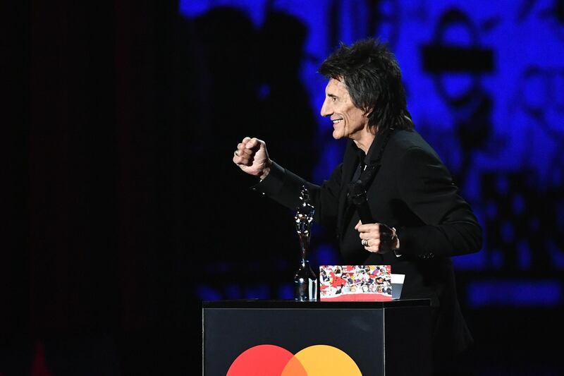The Rolling Stones' Ronnie Wood presents the Best Male Solo Artist award during The BRIT Awards 2020. Getty Images