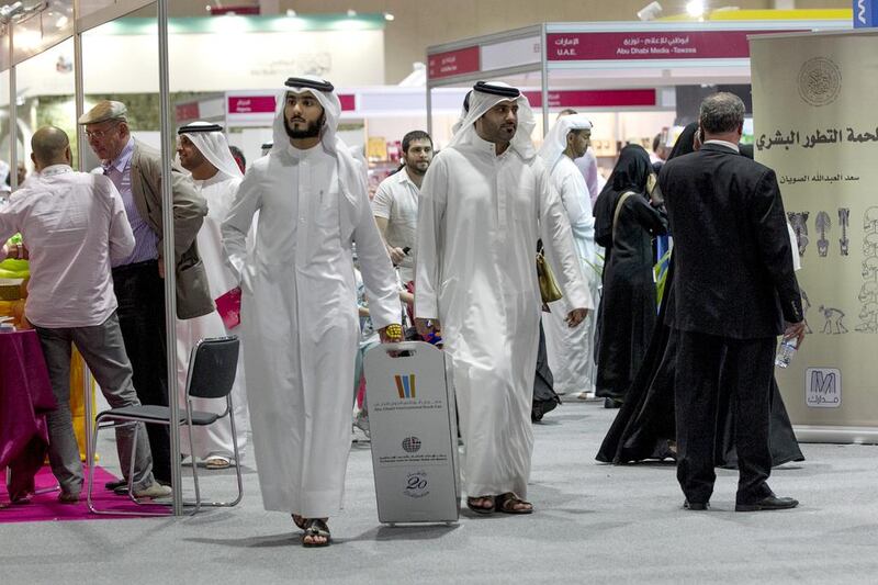 Visitors walk around the Abu Dhabi Book Fair. Mona Al-Marzooqi/ The National