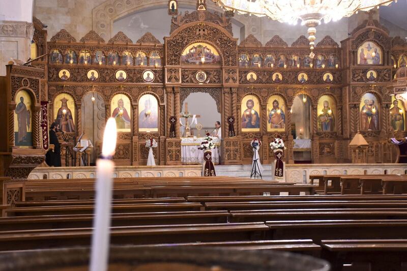 Priests lead a crowdless Easter Sunday mass, during a nationwide lockdown to stem the spread of coronavirus, at the Prophet Elias Greek Orthodox Church in Syria's northern city of Aleppo.   AFP