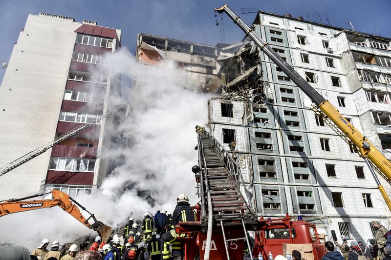 Rescue workers at a residential building hit by a Russian missile in Uman, central Ukraine. EPA