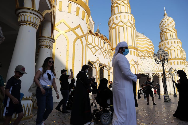 Visitors enter the Global Village gate.