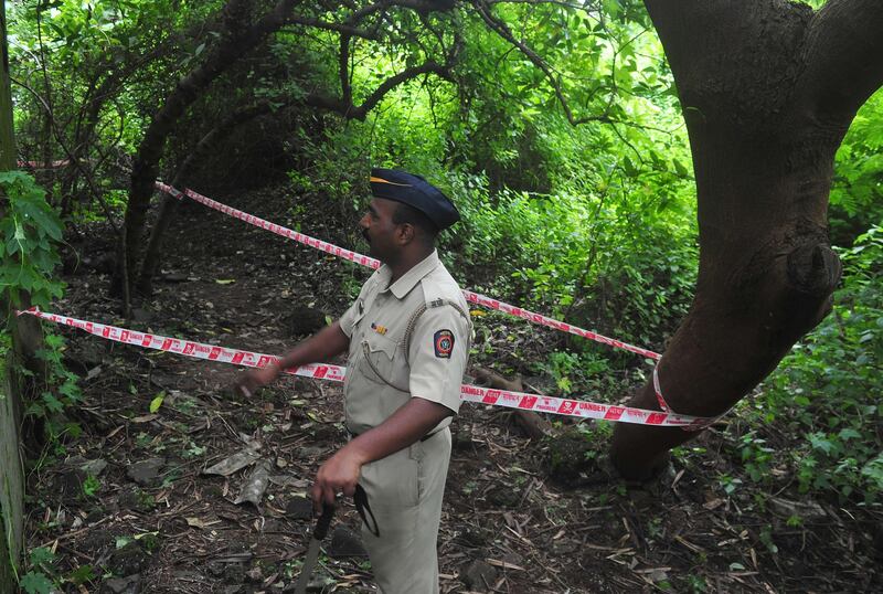 A policeman keeps watch near a police cordon of the crime scene in the Shakti Mills area, where a female photographer was gang-raped overnight,  in Mumbai on August 23, 2013. Five men gang-raped a woman photographer in India's financial hub Mumbai, police said August 23, stirring memories of a similar incident eight months ago in New Delhi which triggered nationwide protests.  AFP PHOTO/Indranil MUKHERJEE
 *** Local Caption ***  788734-01-08.jpg