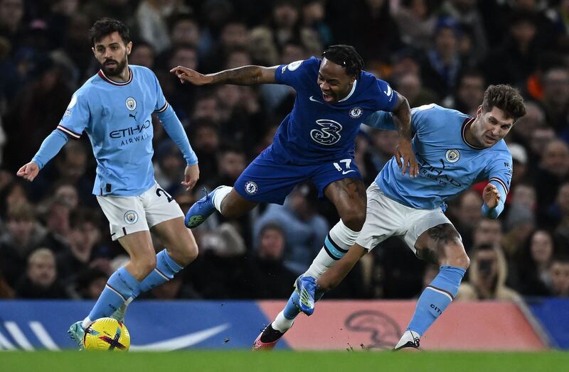 Manchester City defender John Stones tackles Chelsea's Raheem Sterling. AFP