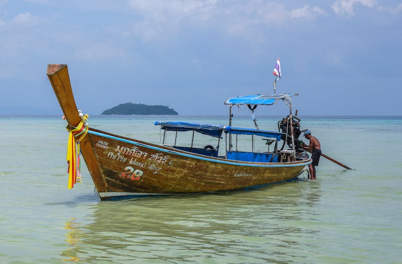 A longtail boat at SAii Phi Phi Island Village Resort waits to take guests to Maya Bay.