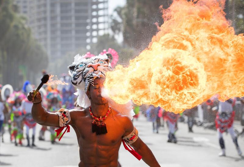 A man blows fire while taking part in the National Parade of Troupes during Carnival, in Santo Domingo, Dominican Republic. EPA