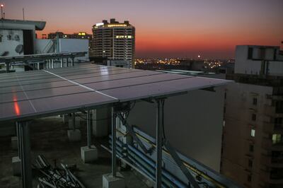 Solar panels on the roof of an apartment block at dusk in Bengaluru. Bloomberg
