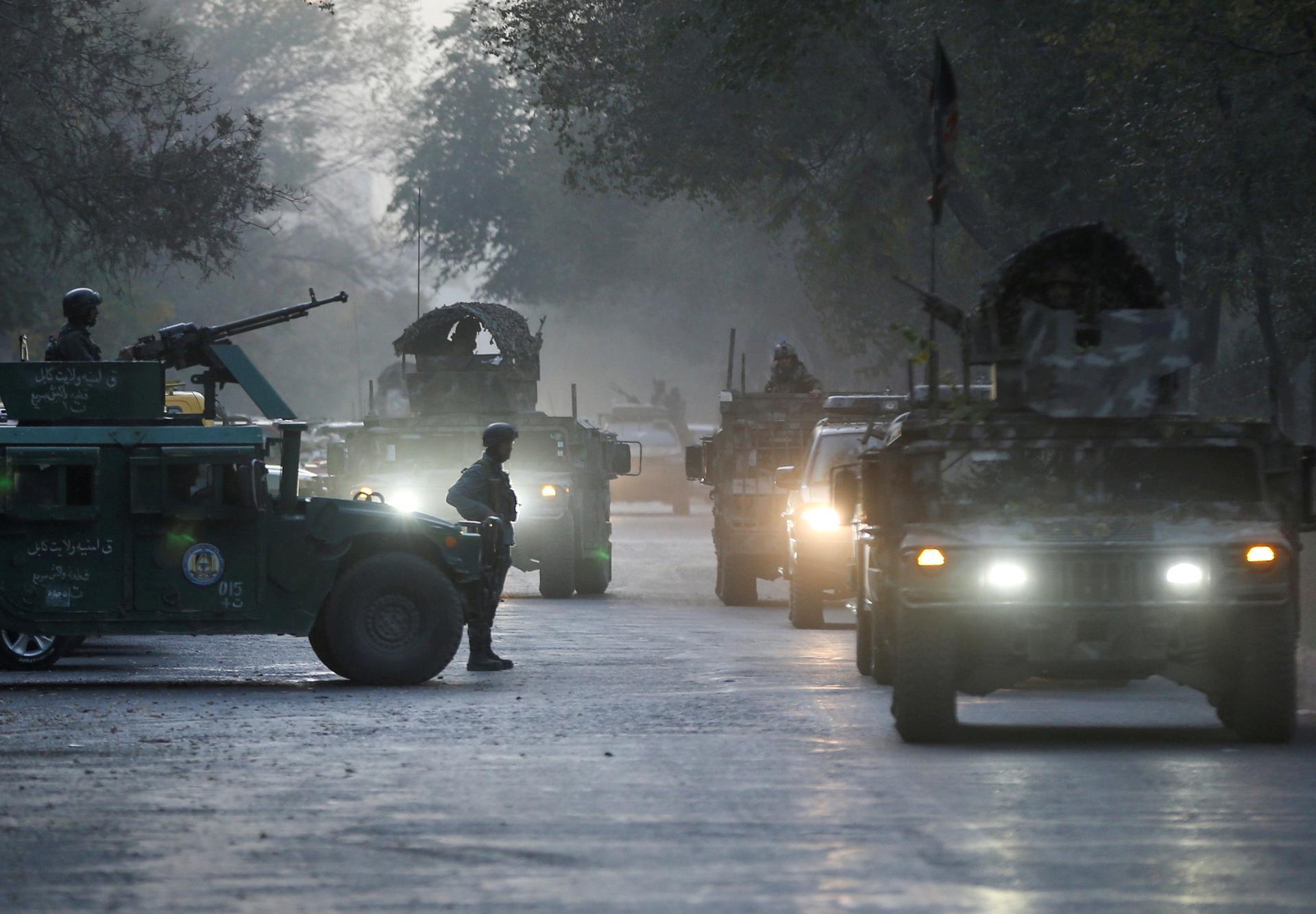 Afghan security forces leave the site of an incident after an attack at the university of Kabul. REUTERS