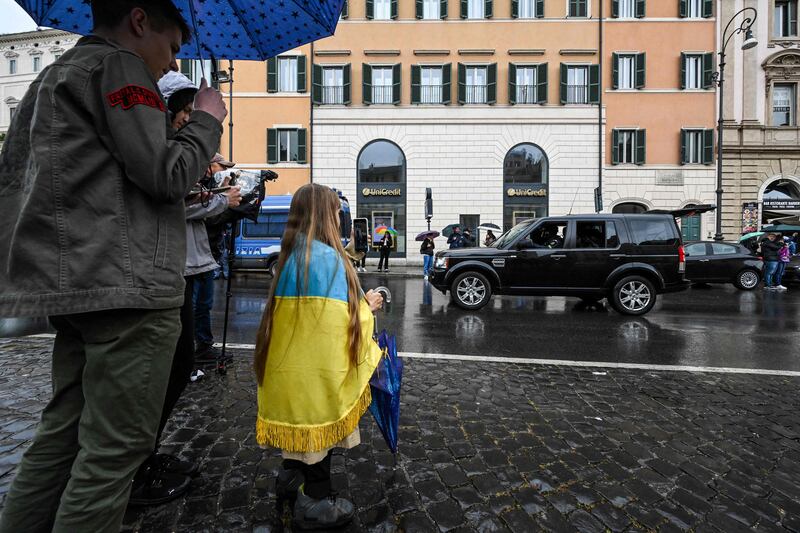 Ukrainians gather as Mr Zelenskyy is driven across Piazza Barberini. AFP