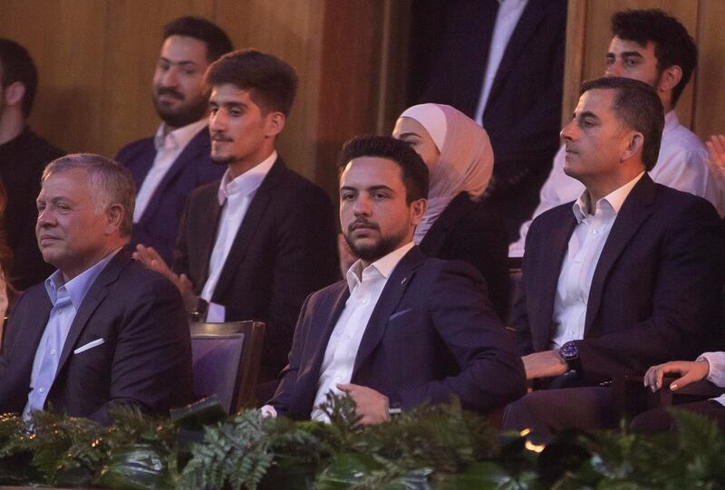 Prince Hussein sits beside his father at the event. EPA