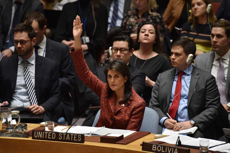 TOPSHOT - US ambassador to the United Nations, Nikki Haley (C) votes in favor to create a investigation of the use of weapons in Syria, at United Nations Headquarters in New York, on April 10, 2018.
Russia on Tuesday vetoed a US-drafted United Nations Security Council resolution that would have set up an investigation into chemical weapons use in Syria following the alleged toxic gas attack in Douma. It was the 12th time that Russia has used its veto power at the council to block action targeting its Syrian ally.
 / AFP PHOTO / HECTOR RETAMAL