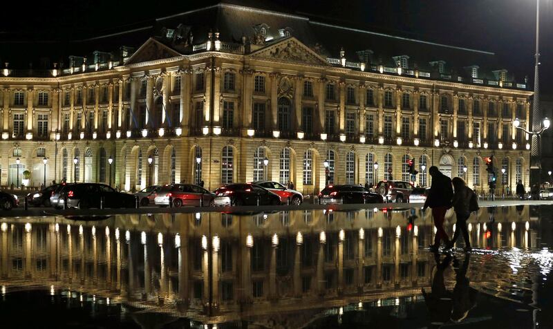 Tourists walk on the Miroir d'Eau (Mirror of Water), a public art piece on the quay of the Garonne river in Bordeaux, southwestern France, October 26, 2014. Bordeaux has renovated its historical district and became in 2007 the largest urban entity to be included on the UNESCO World Heritage Site list.  REUTERS/Regis Duvignau (FRANCE - Tags: TRAVEL SOCIETY) - RTR4BOET