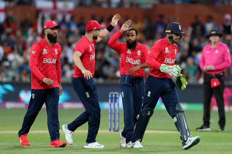 England's Adil Rashid, centre, celebrates taking the wicket of India dangerman Suryakumar Yadav for 14. AFP