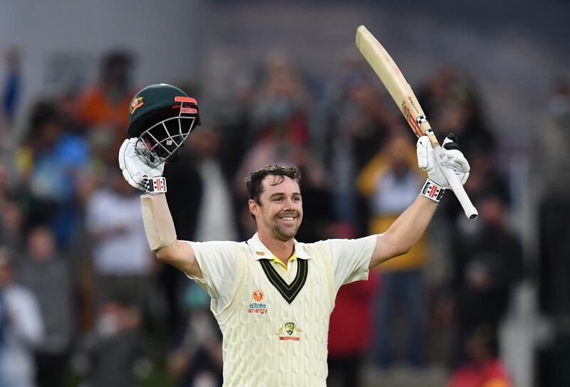 Travis Head raises his bat in celebration after reaching his century for Australia against England in the fifth and final Ashes Test. PA