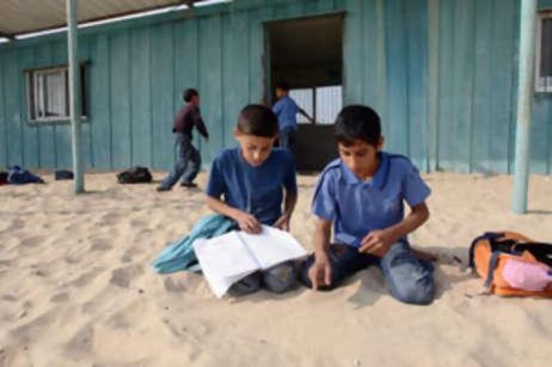 Palestinian pupils at the Al Mawael primary school near Rafah in the southern Gaza Strip. the school, built from old steel containers, is the only one in the area.