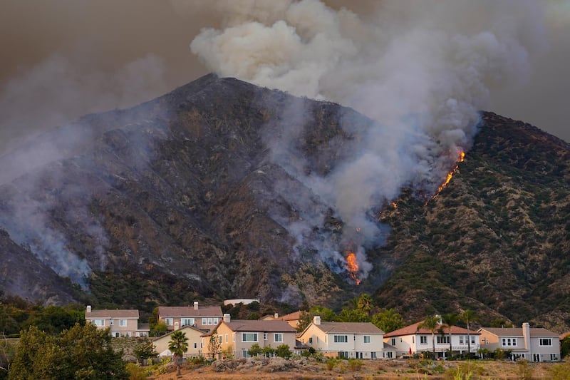 The Ranch Fire burns on a hillside over a residential neighborhood, Thursday, Aug. 13, 2020, in Azusa, California. AP
