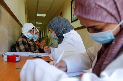Health workers take the personal information of women who wait to receives AstraZeneca vaccine against the coronavirus disease (COVID-19) during a vaccination drive in Tubas, in the Israeli-occupied West Bank March 25, 2021. Picture taken March 25, 2021. REUTERS/Raneen Sawafta