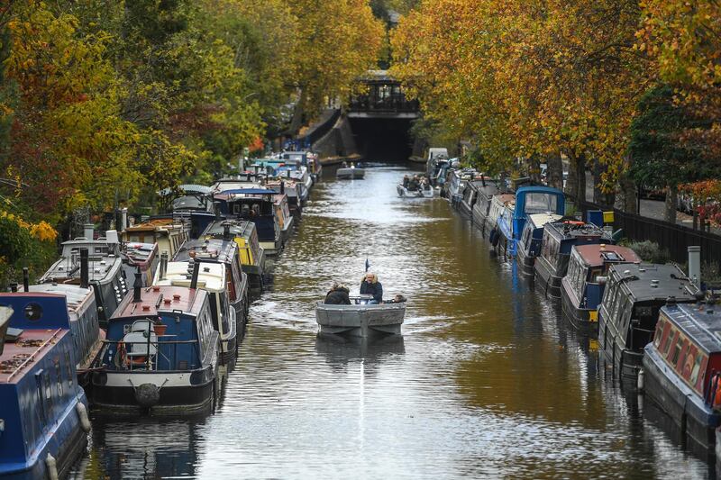 People are seen in a boat alongside autumnal trees in Little Venice in London, England. Prices in Little Venice and Maida Vale dropped by 20%. Getty Images
