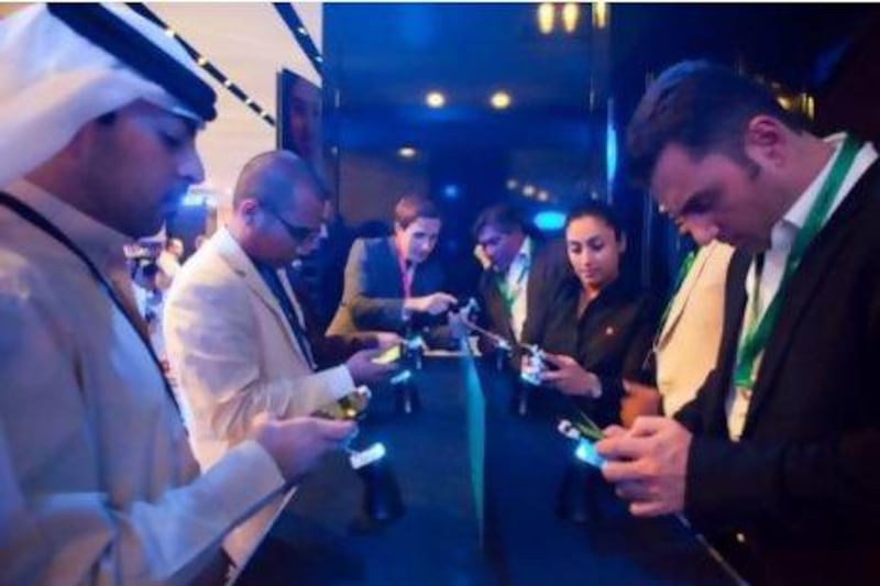 Guests and members of the media test out the new Blackberry 10 at a launch event at the Armani Hotel. Razan Alzayani / The National