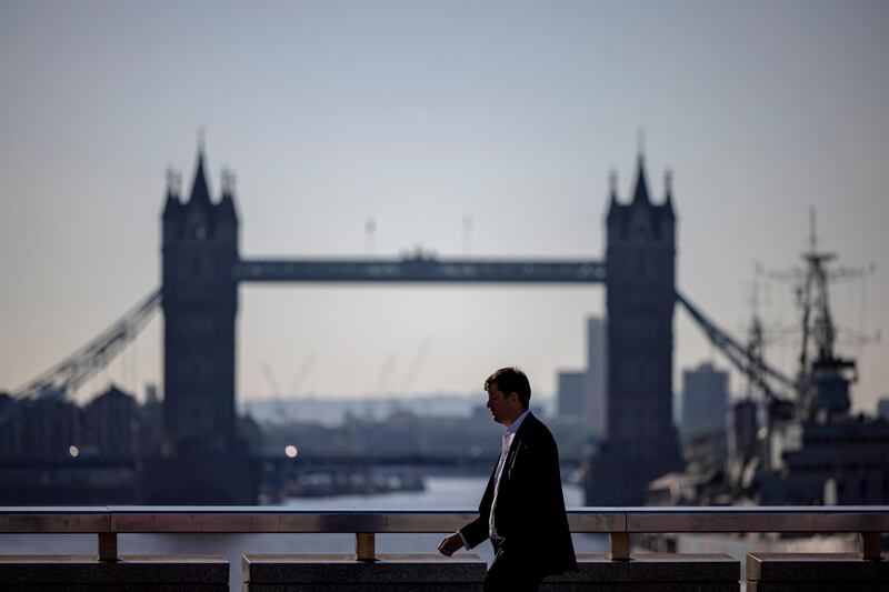 LONDON, ENGLAND - JUNE 14: Morning commuters cross London Bridge on June 14, 2021 in London, England. Under the current timeline, all Covid-19-era restrictions could end June 21, but British officials have raised concern over the virus's Delta variant and rising infection rates. (Photo by Rob Pinney/Getty Images)