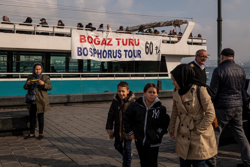 A price banner for a tour of the Bosphorus Strait on the side of a passenger ferry in Istanbul