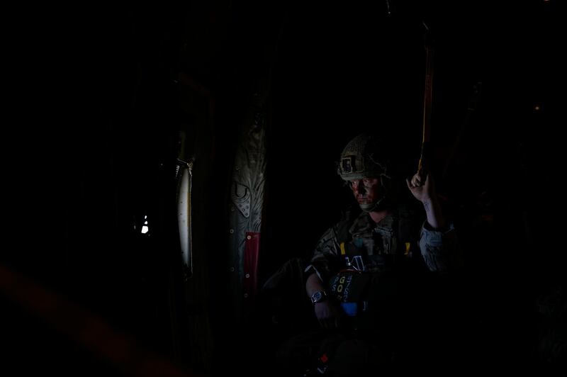 A paratrooper from Britain's 16th Air Assault Brigade waits for the green light to jump from a transport aircraft as part of an exercise with Jordanian soldiers. AP Photo