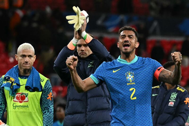 Brazil defender Danilo, right, celebrates victory. AFP