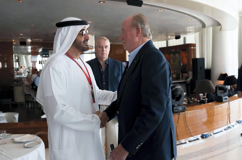 Sheikh Mohammed bin Zayed, Crown Prince of Abu Dhabi and Deputy Supreme Commander of the UAE Armed Forces, greets Juan Carlos I, former King of Spain, at Cipriani restaurant on the second day of the Formula 1 Etihad Airways Abu Dhabi Grand Prix. They are seen with Prince Andrew, Duke of York, back centre. Mohamed Al Hammadi / Crown Prince Court - Abu Dhabi